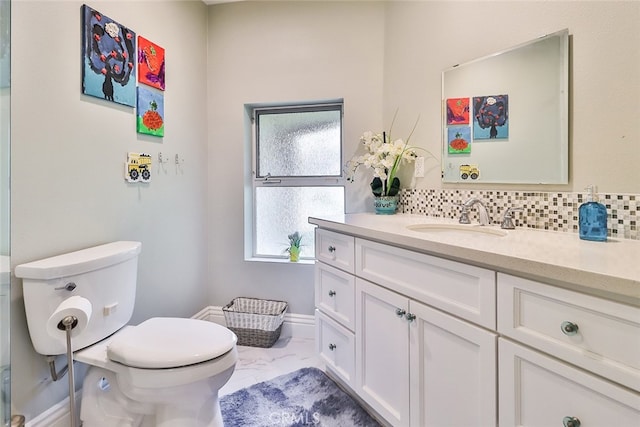 bathroom with backsplash, vanity, and toilet