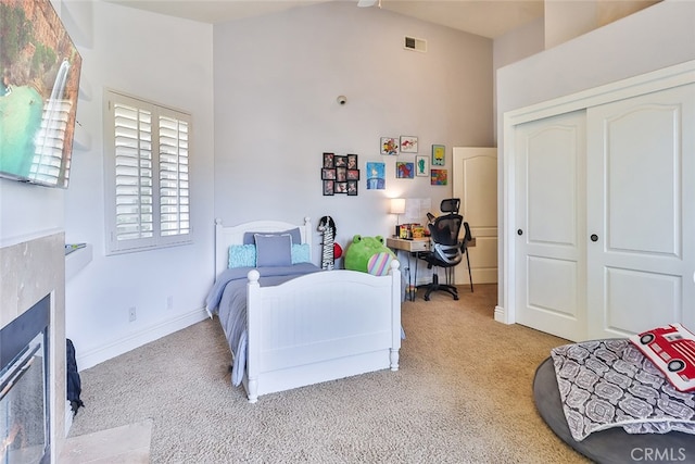 bedroom featuring light carpet, a closet, and vaulted ceiling