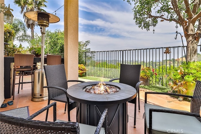 balcony featuring a fire pit and a patio