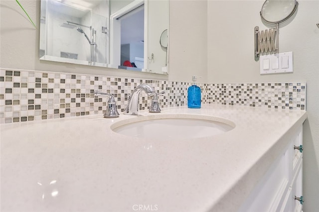 bathroom featuring walk in shower, vanity, and decorative backsplash