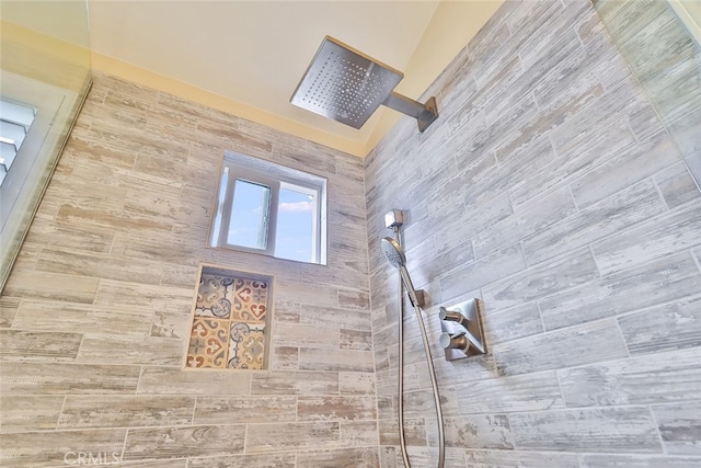 interior details with a tile shower