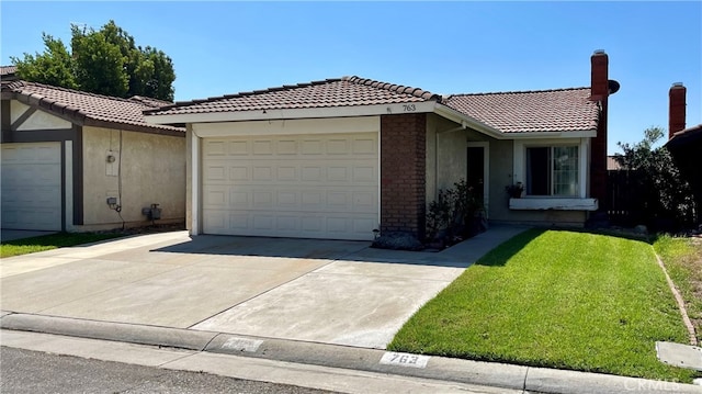 view of front of house with a garage and a front yard