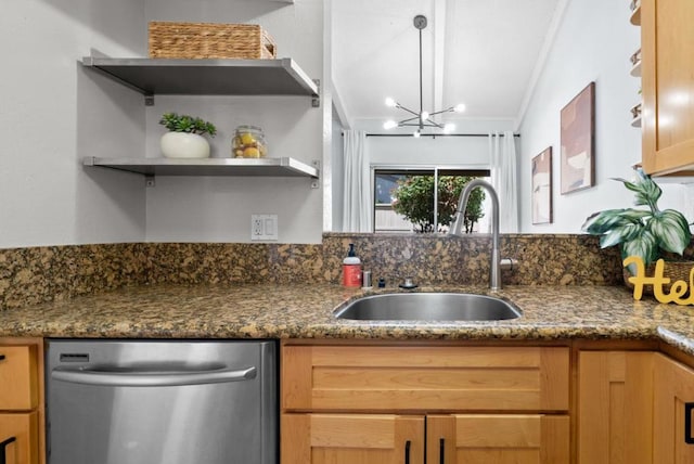 kitchen featuring a chandelier, sink, crown molding, dark stone countertops, and stainless steel dishwasher