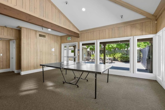 rec room with dark carpet, wooden walls, beam ceiling, and high vaulted ceiling