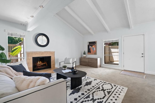 living room featuring lofted ceiling with beams, light carpet, and a premium fireplace