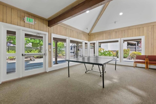 game room featuring wood walls, beam ceiling, carpet, and high vaulted ceiling