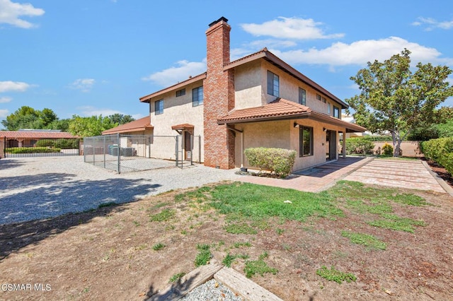 back of house with a patio area