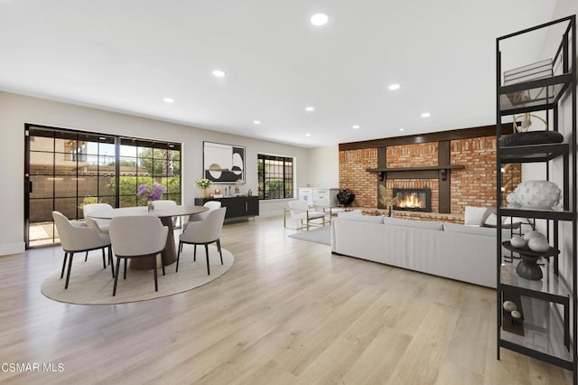 dining room featuring a fireplace and light hardwood / wood-style floors