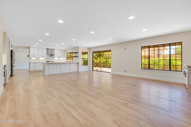 unfurnished living room with light hardwood / wood-style floors