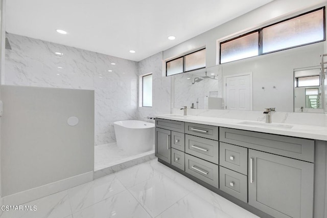 bathroom with separate shower and tub, vanity, and tile walls