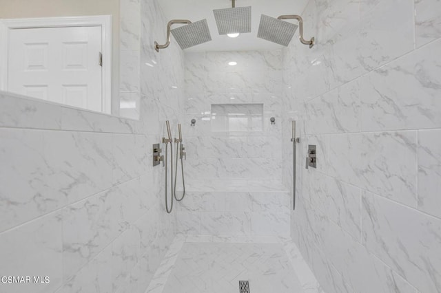 bathroom with a tile shower