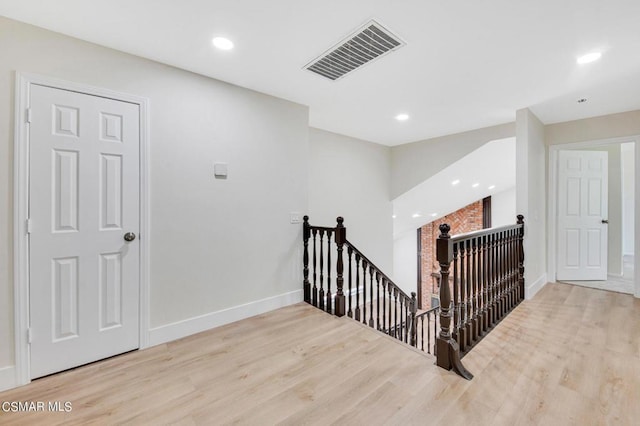 stairs featuring wood-type flooring