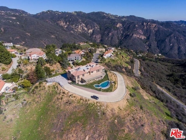 birds eye view of property with a mountain view