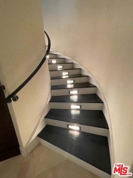 stairs featuring tile patterned flooring