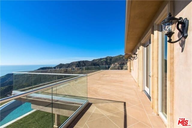 balcony with a water and mountain view