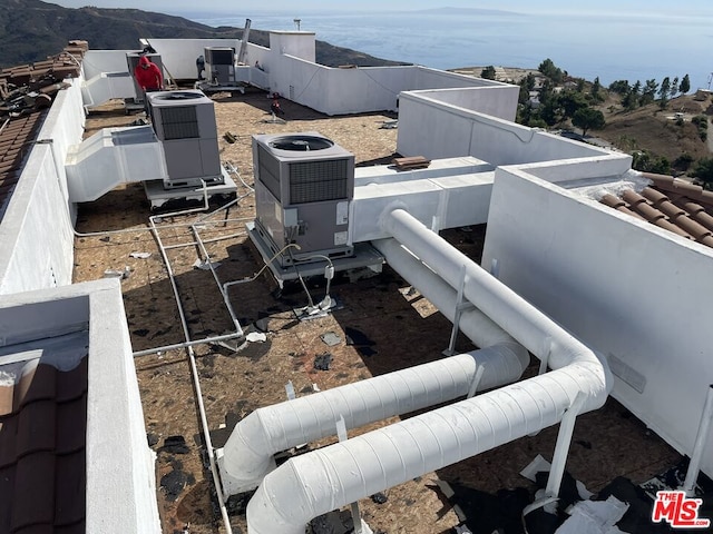 exterior space with a mountain view and cooling unit