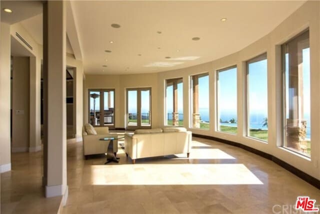 sunroom / solarium featuring a water view