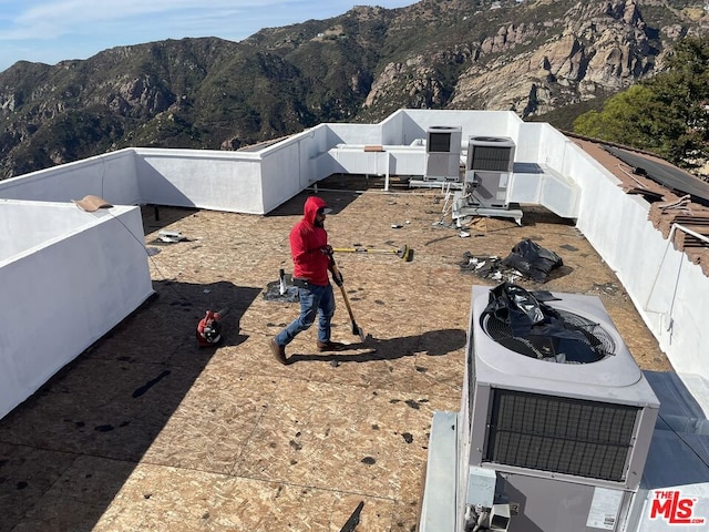 exterior space with a mountain view and central AC