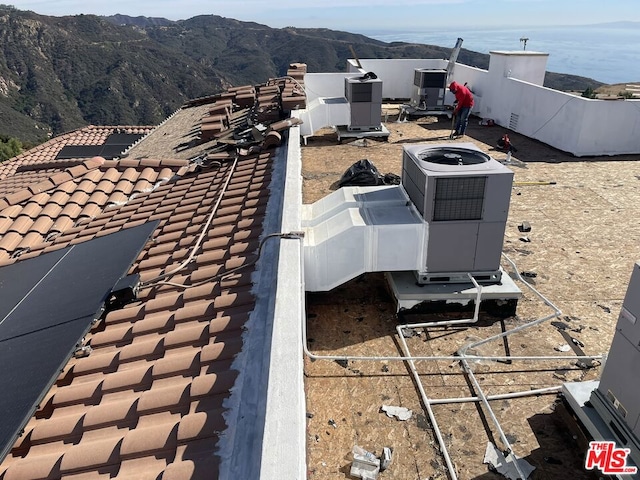 exterior details with a mountain view and cooling unit