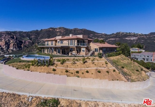 exterior space with a mountain view and a balcony