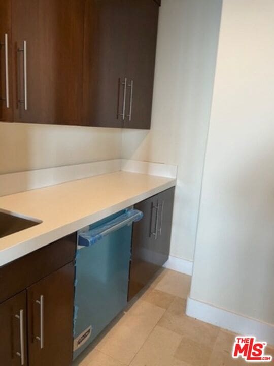 kitchen with dark brown cabinetry and dishwasher