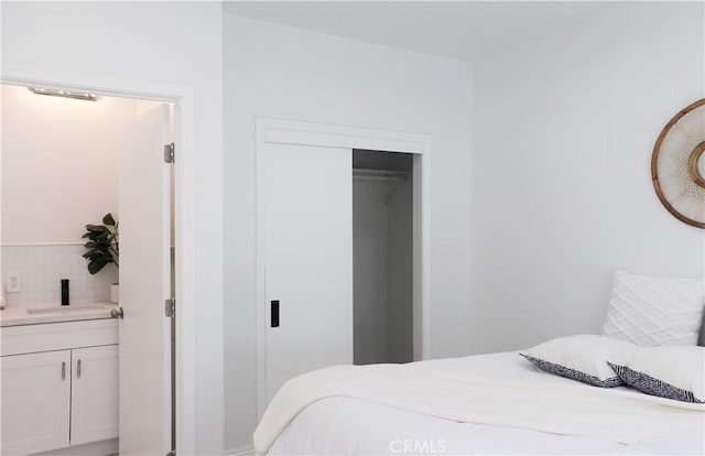 bedroom featuring sink and a closet