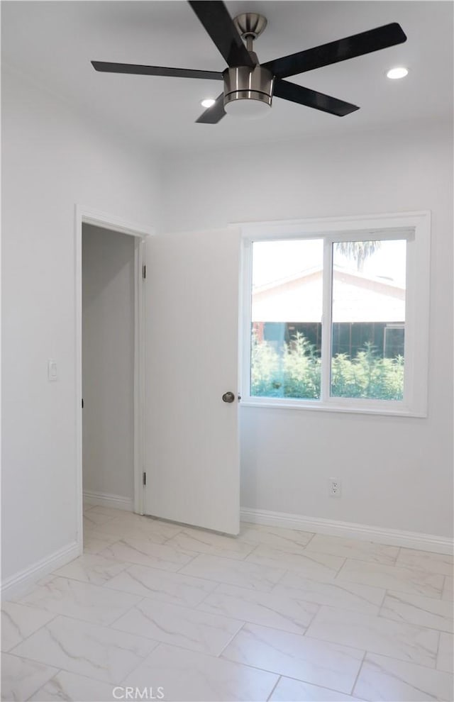 unfurnished room with ceiling fan