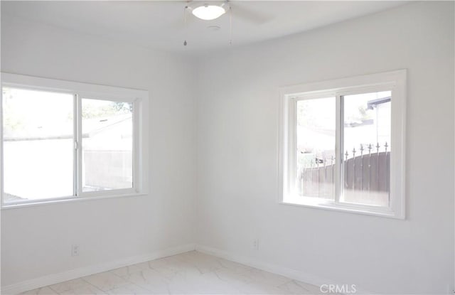 unfurnished room with plenty of natural light and ceiling fan