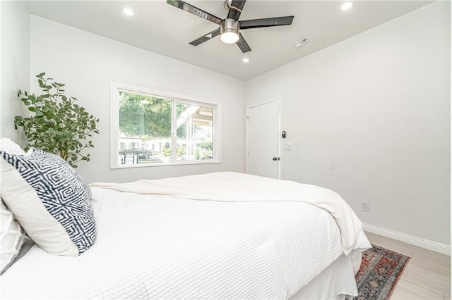 bedroom with ceiling fan and light wood-type flooring