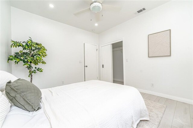 bedroom with ceiling fan and light hardwood / wood-style floors