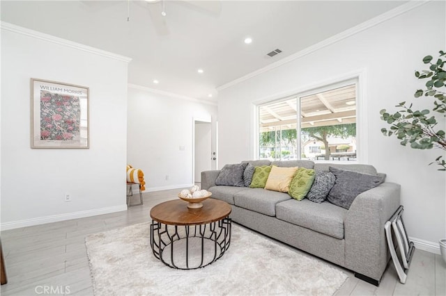 living room with light wood-type flooring, ceiling fan, and crown molding