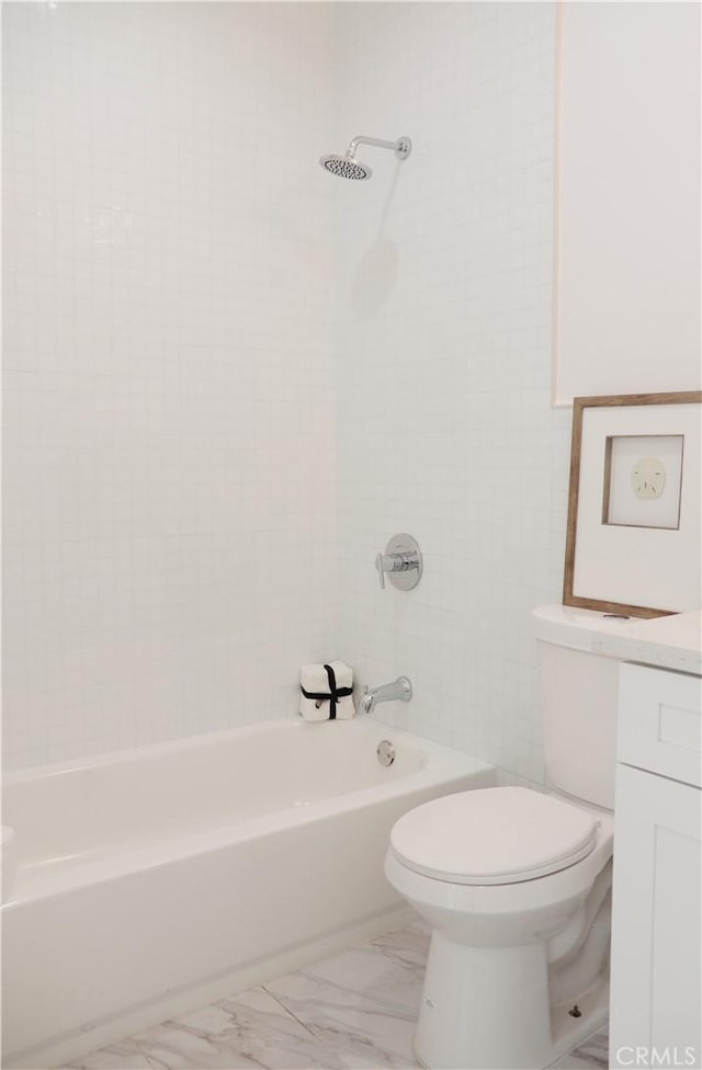 full bathroom featuring tiled shower / bath combo, toilet, and vanity