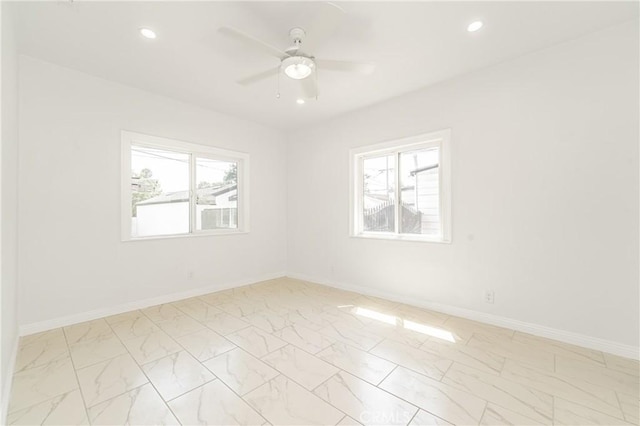 empty room with a wealth of natural light and ceiling fan