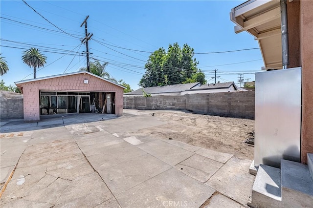 view of patio / terrace featuring an outbuilding and a garage