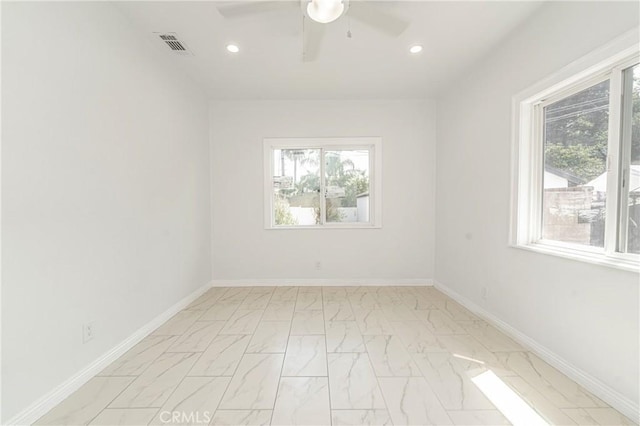 spare room featuring a wealth of natural light and ceiling fan