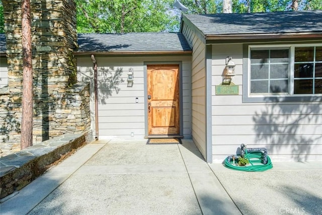 view of exterior entry featuring a patio area