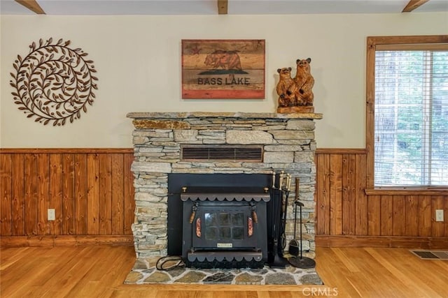 interior details featuring wood walls, wood-type flooring, and a fireplace