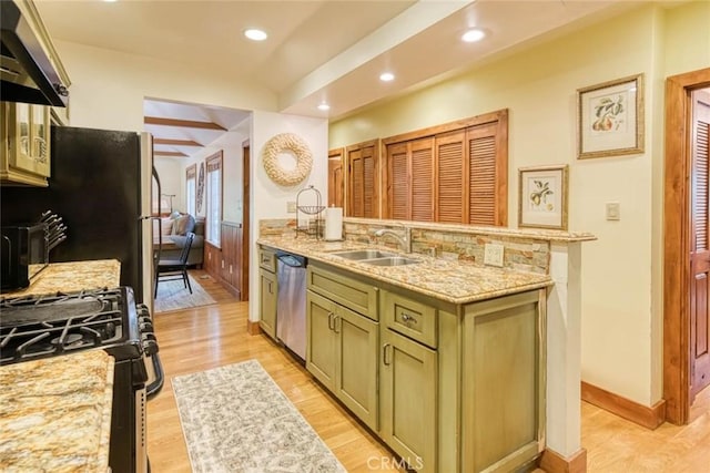 kitchen featuring dishwasher, black gas stove, sink, green cabinetry, and light stone counters