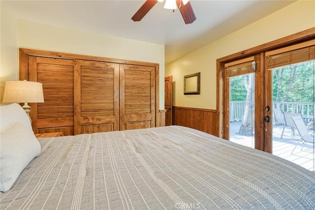 unfurnished bedroom featuring ceiling fan, wood walls, access to outside, and french doors