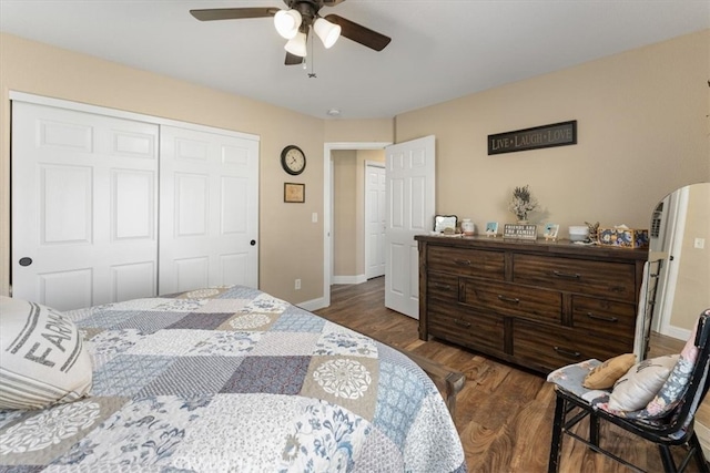 bedroom featuring ceiling fan, a closet, and dark wood-type flooring