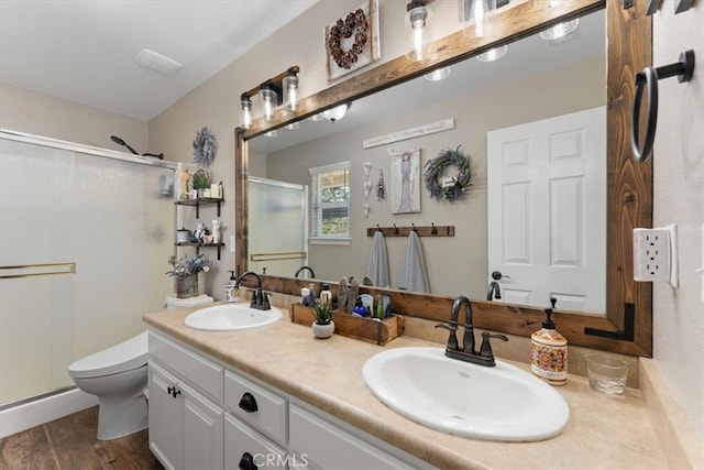 bathroom featuring vanity, hardwood / wood-style floors, toilet, and an enclosed shower