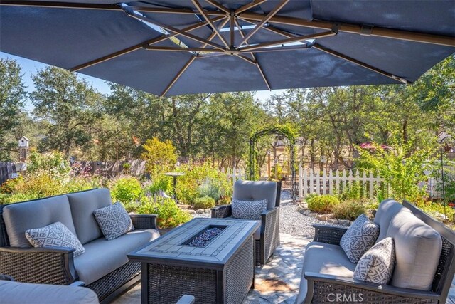 view of patio featuring an outdoor living space with a fire pit