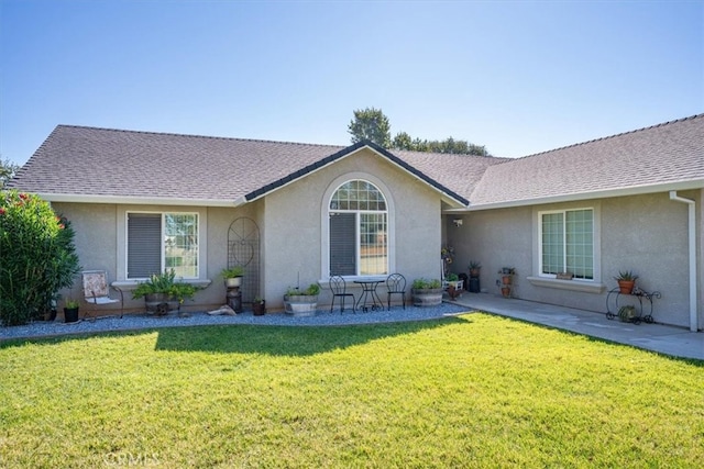 view of front of house featuring a front lawn and a patio area