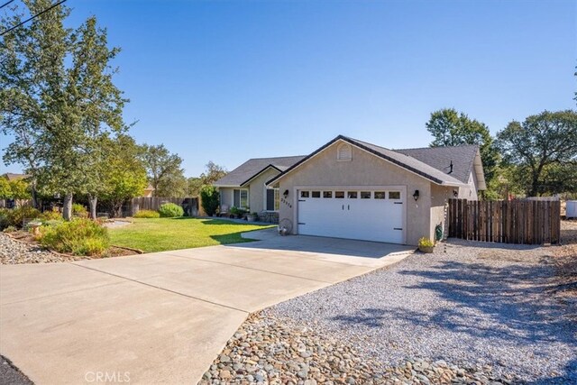 view of front of house with a garage and a front lawn