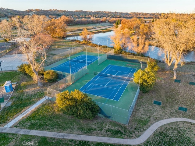 view of sport court featuring a water view