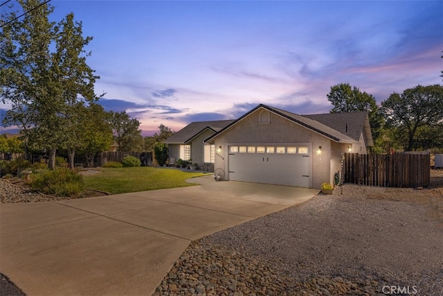 view of front facade with a yard and a garage