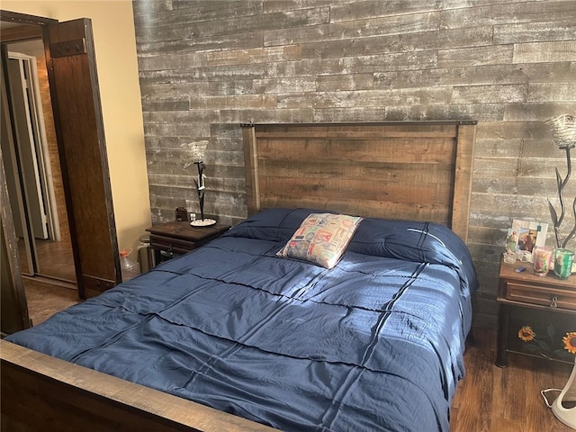 bedroom with dark hardwood / wood-style flooring