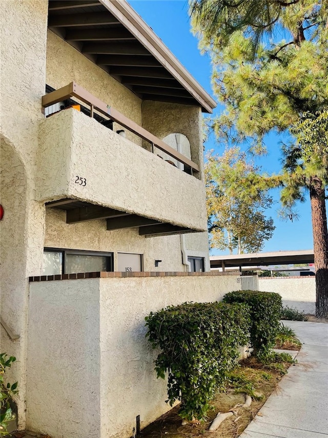 view of side of home featuring a balcony