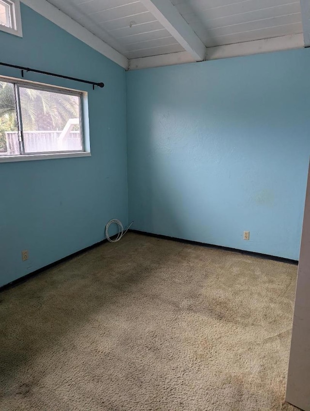 carpeted empty room featuring lofted ceiling with beams and wood ceiling