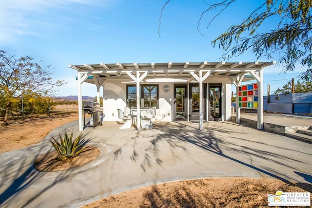 back of property featuring french doors and a pergola